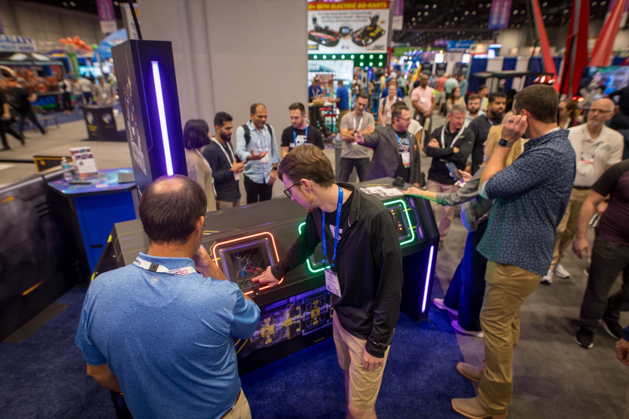 A crowd gathers to watch a DETONATE mission at IAAPA 2025